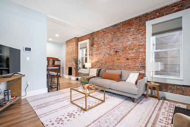 453-455 S 22nd St, Columbus, OH 43205 - living room featuring brick wall, wood finished floors, and baseboards