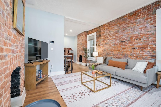 453-455 S 22nd St, Columbus, OH 43205 - living area with wood finished floors, a fireplace, brick wall, baseboards, and recessed lighting