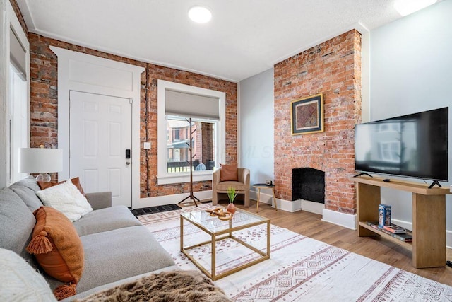 453-455 S 22nd St, Columbus, OH 43205 - living area with brick wall, wood finished floors, a fireplace, and baseboards