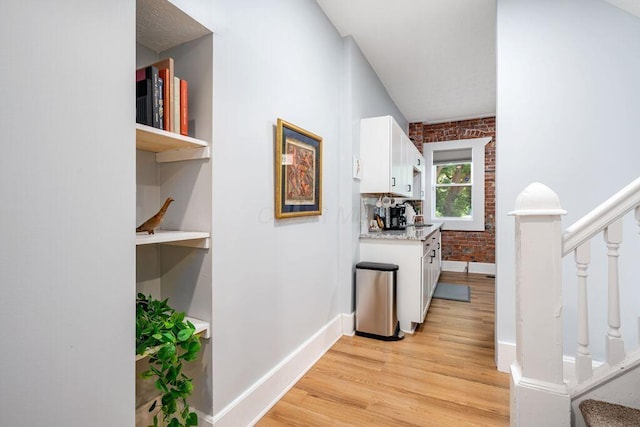 453-455 S 22nd St, Columbus, OH 43205 - corridor featuring stairway, light wood-style floors, baseboards, brick wall, and a sink