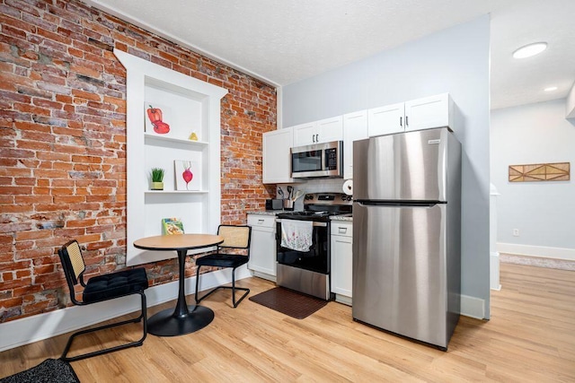 453-455 S 22nd St, Columbus, OH 43205 - kitchen with stainless steel appliances, light wood-style floors, baseboards, white cabinetry, and built in features