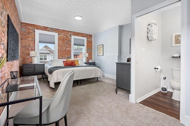 453-455 S 22nd St, Columbus, OH 43205 - carpeted bedroom with brick wall, baseboards, and a textured ceiling
