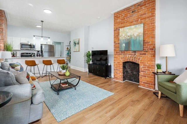 453-455 S 22nd St, Columbus, OH 43205 - living area with light wood finished floors, a fireplace, baseboards, and recessed lighting