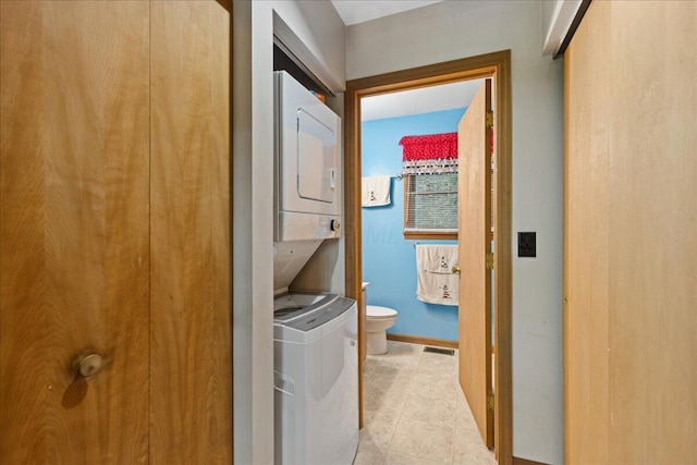 512 Natchez Ln, Sugar Grove, OH 43155 - laundry area featuring stacked washing machine and dryer and light tile patterned flooring