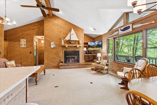 512 Natchez Ln, Sugar Grove, OH 43155 - living room featuring wood walls, high vaulted ceiling, ceiling fan, a glass covered fireplace, and carpet flooring