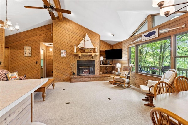 512 Natchez Ln, Sugar Grove, OH 43155 - living area with wood walls, high vaulted ceiling, ceiling fan, a glass covered fireplace, and carpet floors