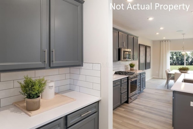 1573 Crest Dr Lot 2560, Galena, OH 43021 - kitchen with stainless steel appliances, gray cabinetry, light wood-style floors, recessed lighting, and backsplash