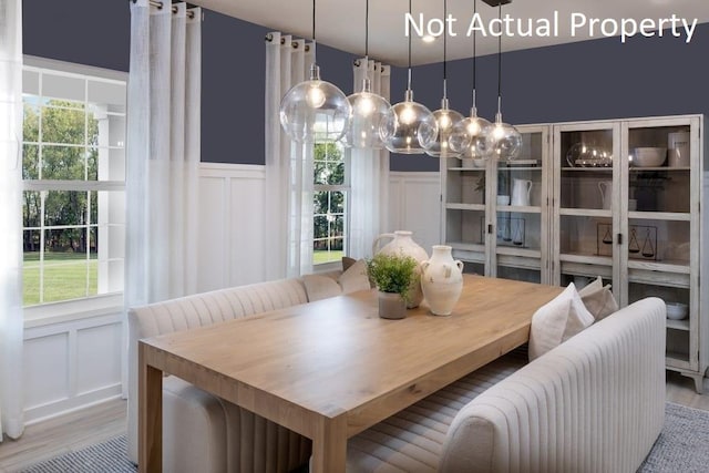 1573 Crest Dr Lot 2560, Galena, OH 43021 - dining space featuring a decorative wall, wainscoting, and wood finished floors