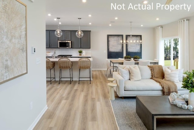 1573 Crest Dr Lot 2560, Galena, OH 43021 - living area with light wood-style flooring, recessed lighting, baseboards, and a chandelier