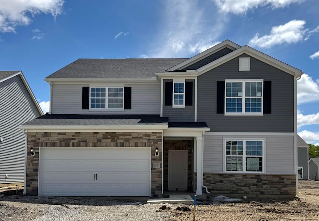 1573 Crest Dr Lot 2560, Galena, OH 43021 - view of front of home featuring stone siding, an attached garage, driveway, and roof with shingles