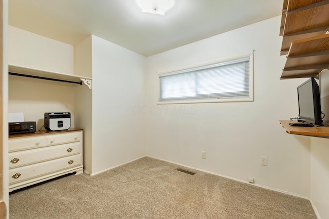 unfurnished bedroom featuring carpet flooring and baseboards
