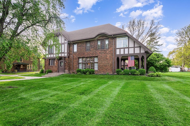 404 Rawling St, Washington Court House, OH 43160 - english style home featuring a front yard, brick siding, and a shingled roof