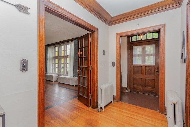 404 Rawling St, Washington Court House, OH 43160 - foyer with radiator heating unit, crown molding, and light wood-style floors