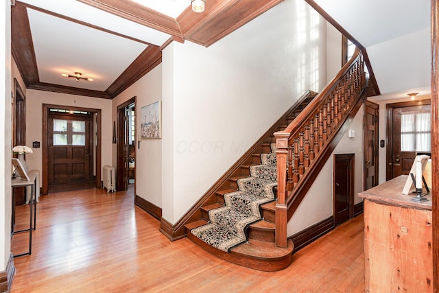 404 Rawling St, Washington Court House, OH 43160 - foyer entrance with light wood finished floors, stairway, radiator, plenty of natural light, and crown molding