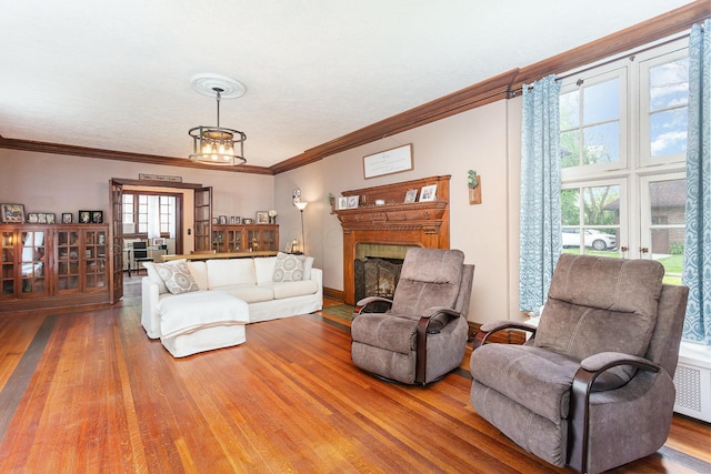 404 Rawling St, Washington Court House, OH 43160 - living room featuring hardwood / wood-style floors, crown molding, a fireplace, and radiator