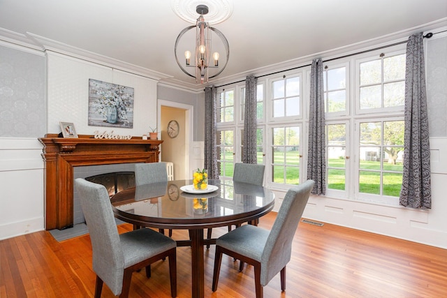 404 Rawling St, Washington Court House, OH 43160 - dining room featuring a chandelier, ornamental molding, light wood-style floors, a wainscoted wall, and a decorative wall