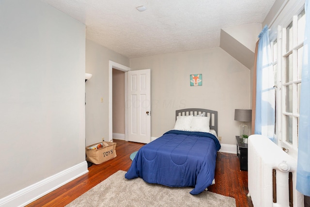 404 Rawling St, Washington Court House, OH 43160 - bedroom featuring wood finished floors, radiator heating unit, a textured ceiling, and baseboards