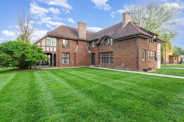 404 Rawling St, Washington Court House, OH 43160 - rear view of house with a chimney, brick siding, and a lawn