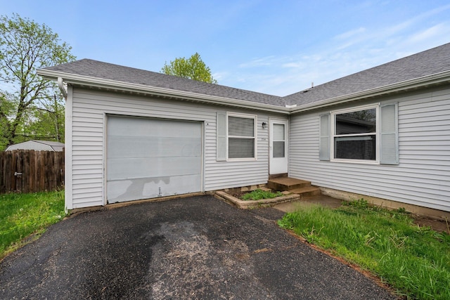 2512 Gantz Rd, Grove City, OH 43123 - ranch-style house featuring asphalt driveway, fence, and roof with shingles