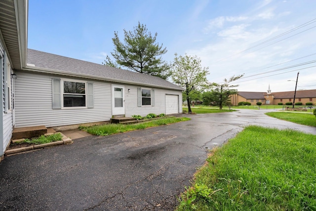 2512 Gantz Rd, Grove City, OH 43123 - view of front facade with a garage, a shingled roof, and driveway
