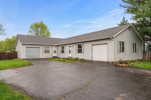 2512 Gantz Rd, Grove City, OH 43123 - ranch-style house with an attached garage, fence, roof with shingles, and driveway