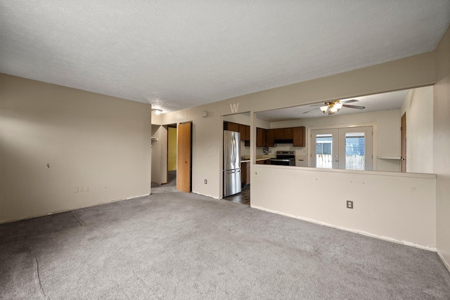 2512 Gantz Rd, Grove City, OH 43123 - unfurnished living room with dark carpet, ceiling fan, and a textured ceiling