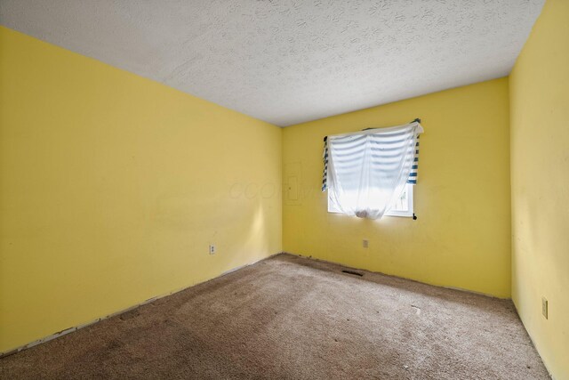 2512 Gantz Rd, Grove City, OH 43123 - carpeted empty room with a textured ceiling