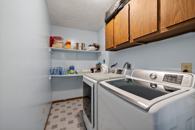 2512 Gantz Rd, Grove City, OH 43123 - laundry area featuring cabinet space, light floors, washing machine and dryer, baseboards, and a textured ceiling