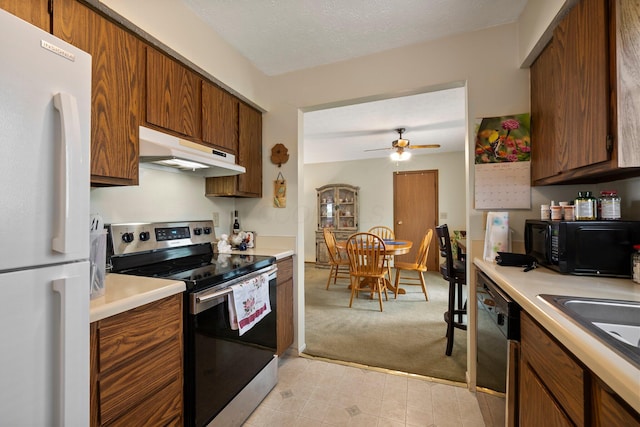 2512 Gantz Rd, Grove City, OH 43123 - kitchen with black appliances, under cabinet range hood, light colored carpet, light countertops, and a ceiling fan
