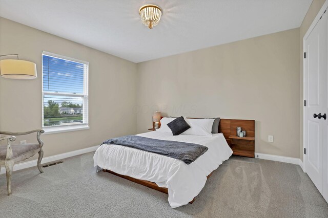 carpeted bedroom with baseboards