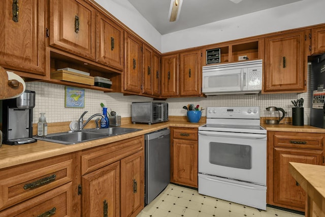 kitchen with white appliances, a sink, open shelves, and light flooring