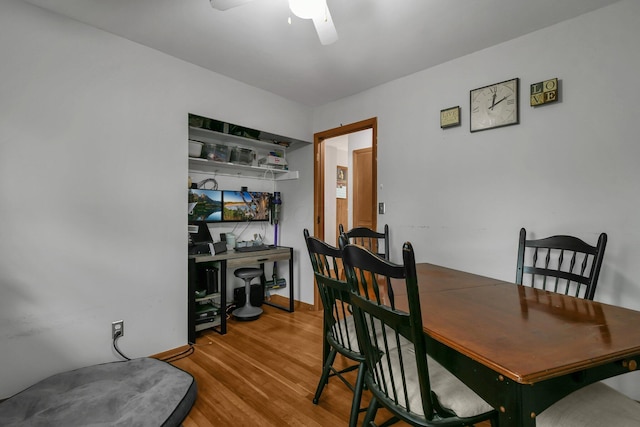 dining space with wood finished floors, a ceiling fan, and a desk
