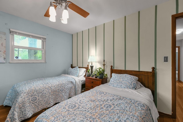 bedroom with wood finished floors and a ceiling fan