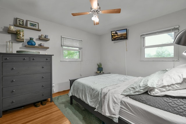 bedroom featuring light wood-type flooring and a ceiling fan