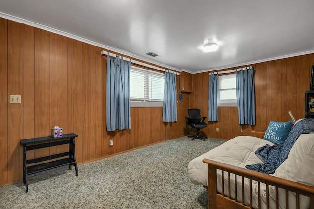 bedroom featuring wood walls and crown molding