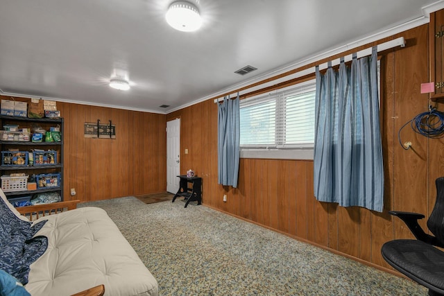 living area with ornamental molding and wood walls