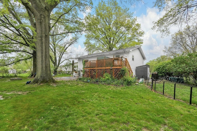 view of yard with a wooden deck, a storage unit, and an outdoor structure