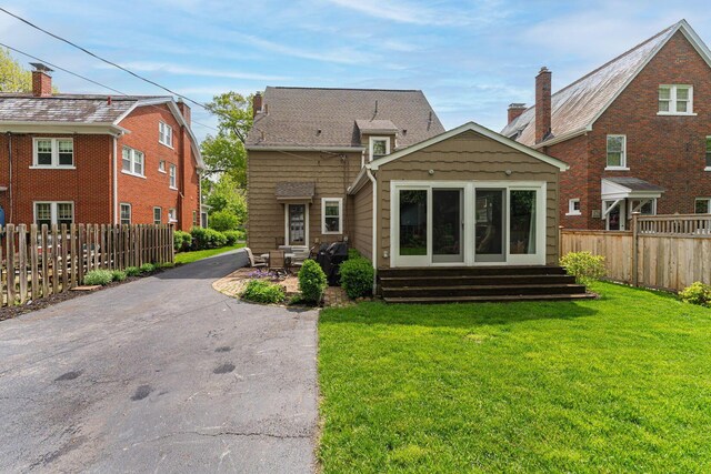 rear view of house with entry steps and a patio