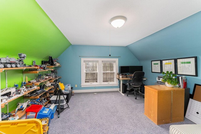 carpeted office space with lofted ceiling
