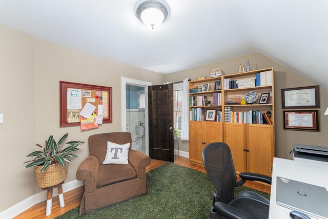 office with wood finished floors, baseboards, and lofted ceiling