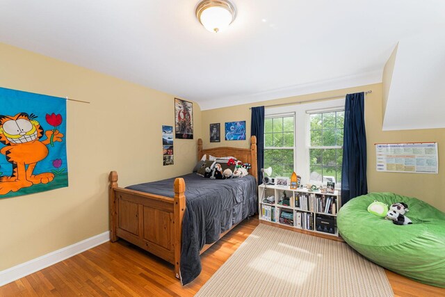 bedroom with wood finished floors and baseboards