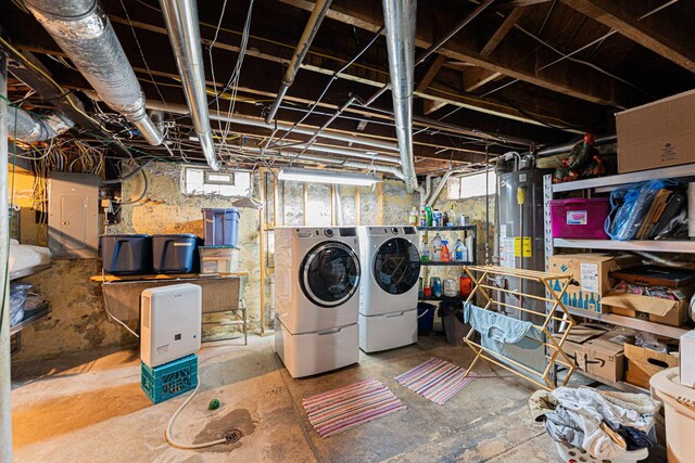 basement featuring washer and dryer and water heater