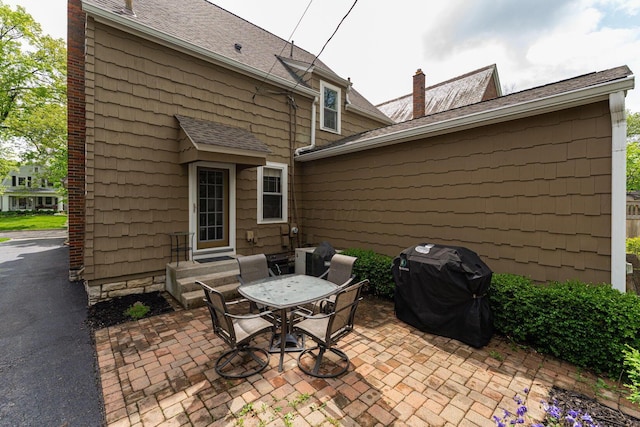 view of patio with a grill and entry steps