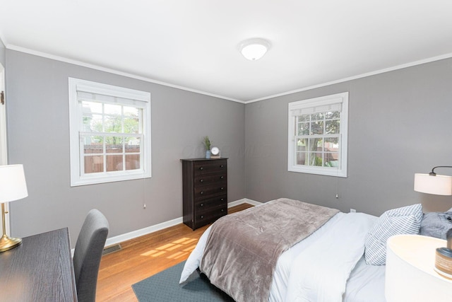 1324 Haines Ave, Columbus, OH 43212 - bedroom with wood finished floors, baseboards, and crown molding