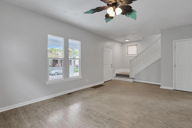 1617 Arlington Ave, Columbus, OH 43211 - unfurnished living room with stairs, baseboards, ceiling fan, and wood finished floors