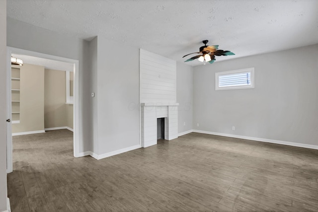 1617 Arlington Ave, Columbus, OH 43211 - unfurnished living room with ceiling fan, baseboards, dark wood-type flooring, a fireplace, and a textured ceiling
