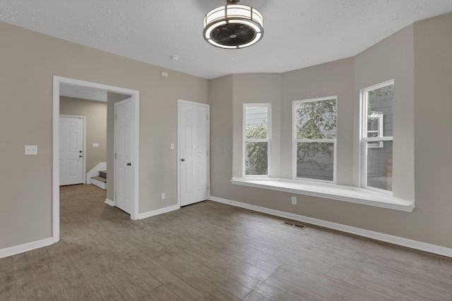 1617 Arlington Ave, Columbus, OH 43211 - unfurnished bedroom with baseboards and wood finished floors