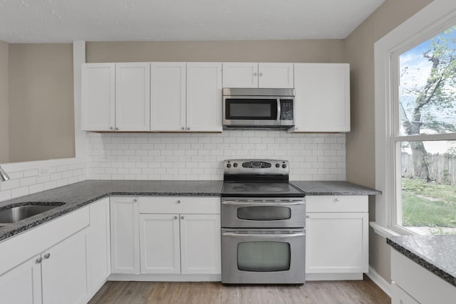 1617 Arlington Ave, Columbus, OH 43211 - kitchen with stainless steel appliances, a sink, and white cabinets