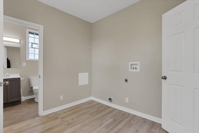 1617 Arlington Ave, Columbus, OH 43211 - laundry area featuring hookup for an electric dryer, washer hookup, light wood finished floors, and baseboards