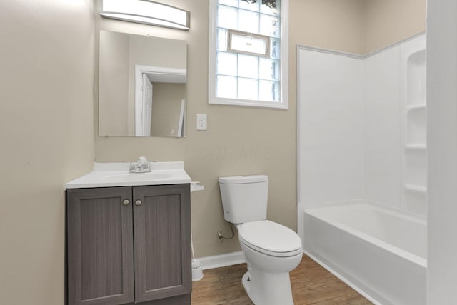 1617 Arlington Ave, Columbus, OH 43211 - full bath with toilet, wood finished floors, vanity, baseboards, and shower / bath combination